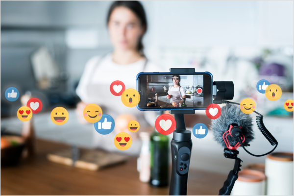 A video content creator streaming for their audience with live reactions in the foreground.